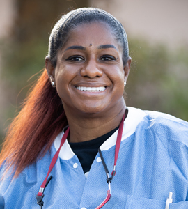 Here's a short alt tag for the image: Smiling dental professional headshot.