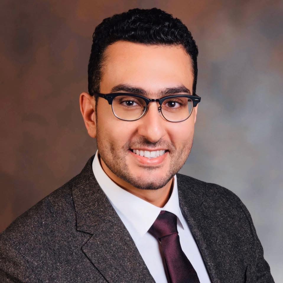 Man wearing glasses and a suit smiling. Man wearing glasses and a suit smiling.